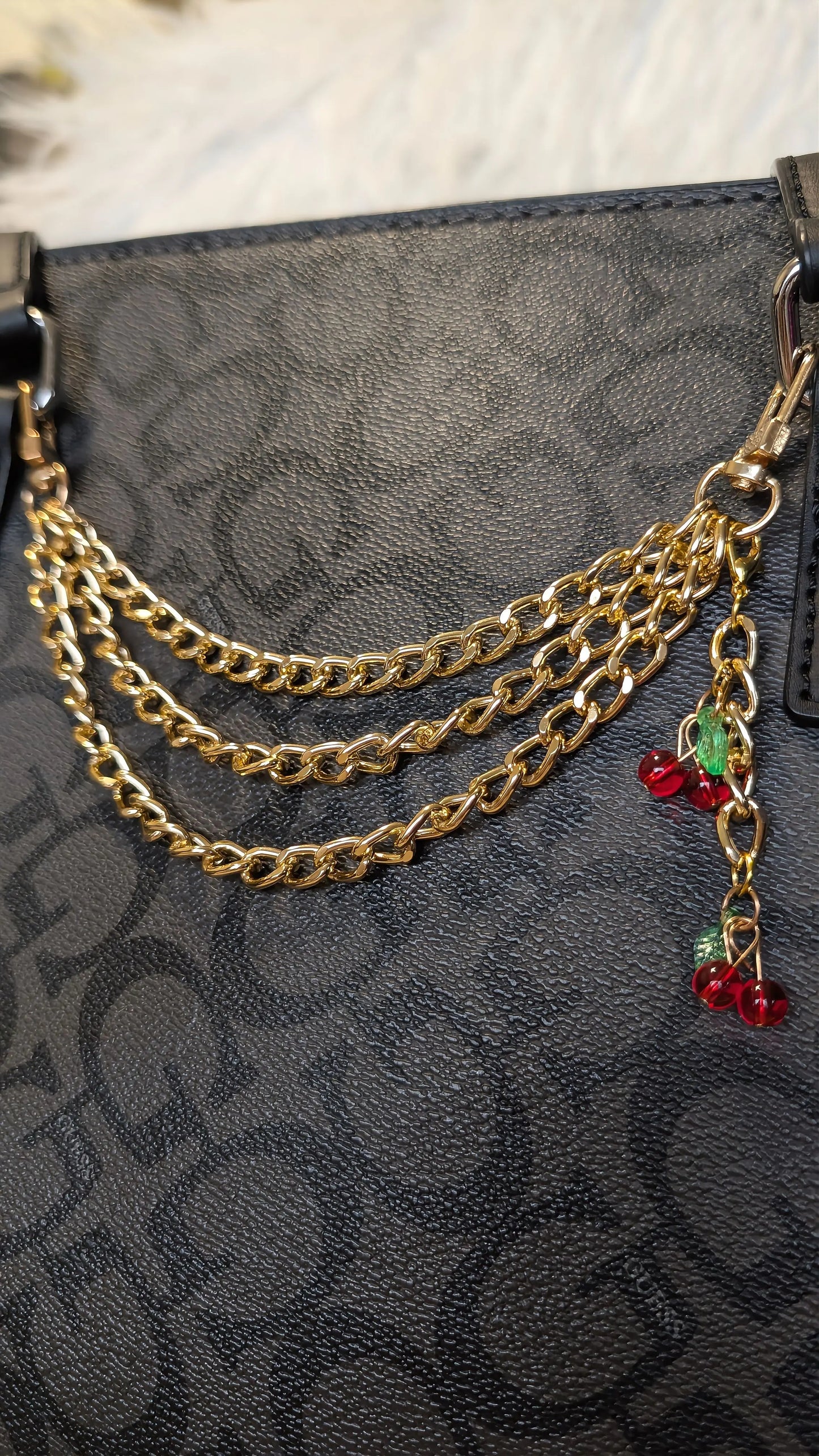 Gold chain accessory on a black textured surface