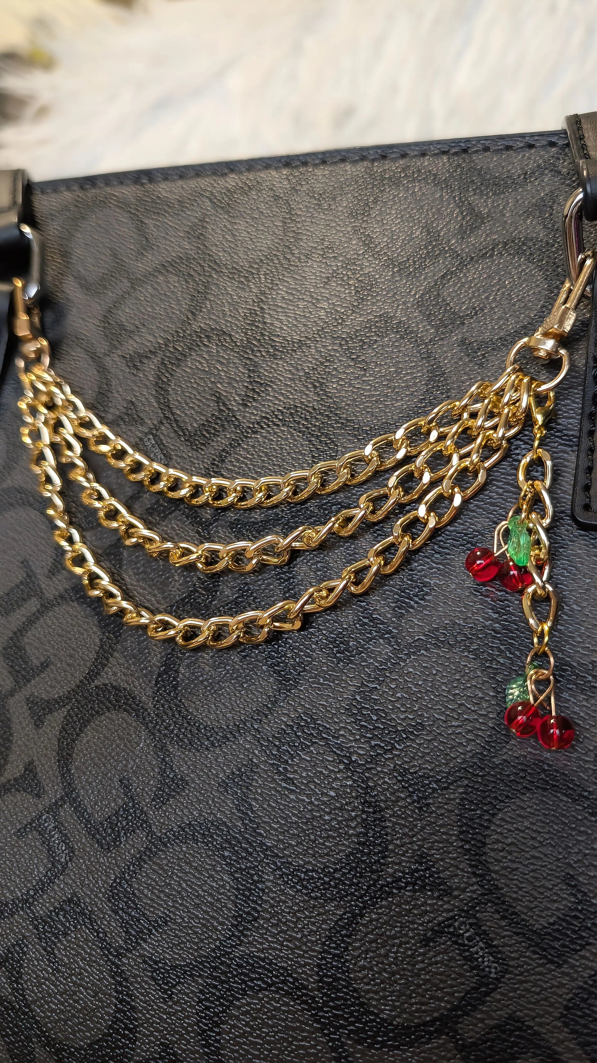 Gold chain accessory on a black textured surface