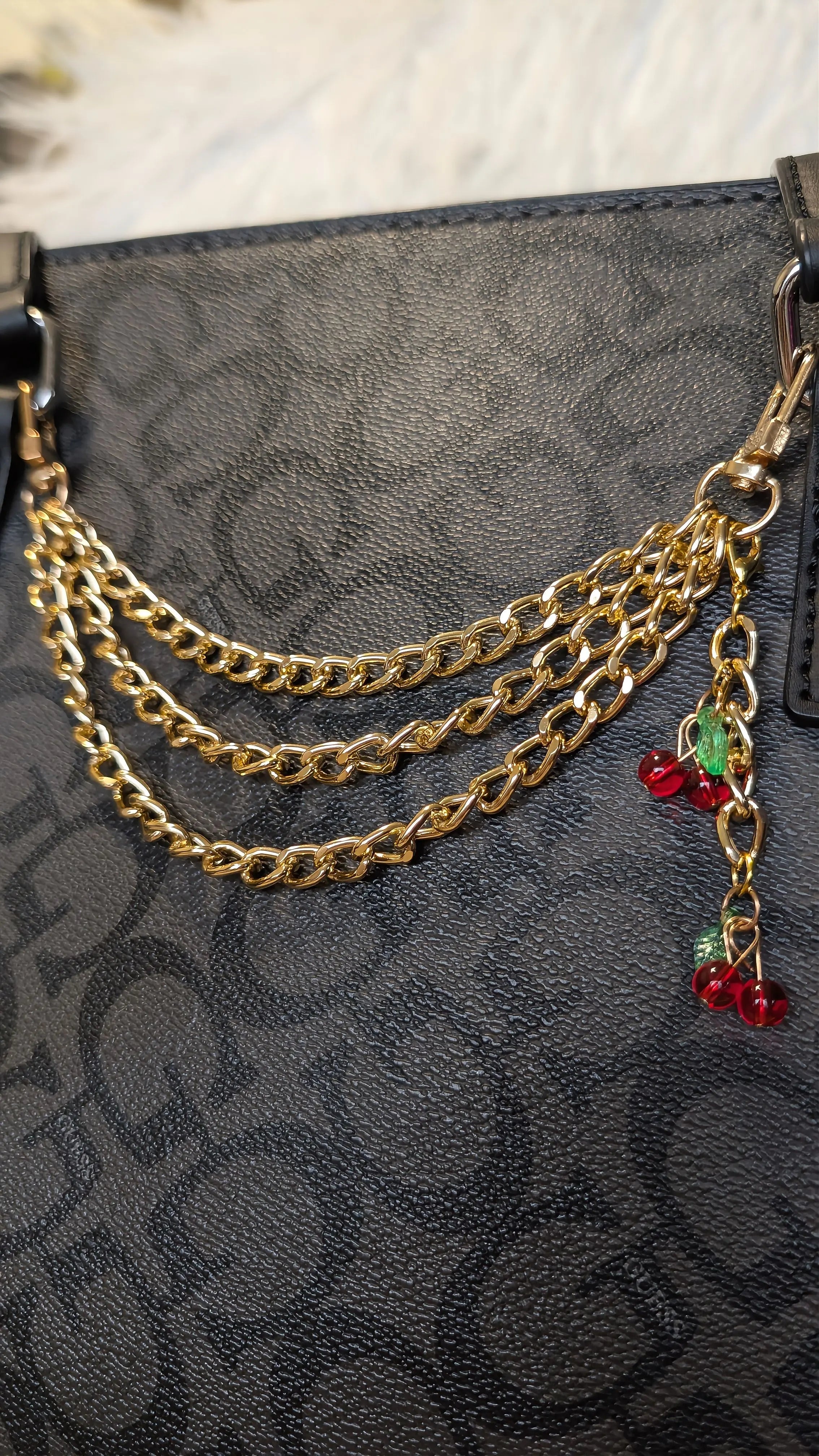 Gold chain accessory on a black textured surface